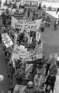 Action Day Care and Metro Toronto Daycare Workers march at the 1983 International Women's Day March in Toronto. The Osgoode Women's Caucus is also in the photo.