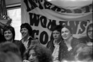 This undated photograph of International Women's Day Committee banner was taken at a Toronto International Women's Day Rally. IWDC activists Linda Briskin and Lynda Yanz are shown.