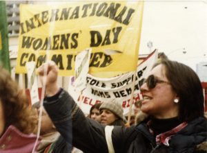 A photo of the International Women's Day Committee banner and contingent at a Toronto IWD march.