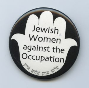 Created by the Jewish Women's Committee to End the Occupation in Toronto, these buttons in both English and Hebrew represented a hand saying stop, we are against the occupation of Palestinian land. These buttons were worn prominently at the weekly vigils at the Israeli Consulate and were the subject of an attempted boycott of the Toronto Women's Bookstore, that sold them.