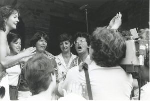 This photo was taken at the 1983 raid of the Toronto Morgentaler clinic and shows Judy Rebick speaking to protesting women. The Toronto clinic, opened in June by Dr. Morgentaler, was raided in July and police charged Drs. Morgentaler, Scott and Smoling with conspiracy to procure a miscarriage.