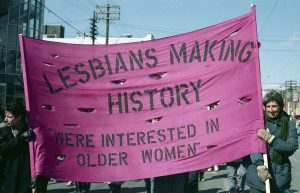 Lesbians Making History joined the Toronto International Women's Day March in 1987. Lorie Rotenberg (holding banner on right) was a member this collective which aimed to record the stories and struggles of older lesbians. Photograph by Amy Gottlieb.