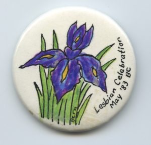 Irises in bloom decorate the button for British Columbia's Lesbian Celebration in 1983.