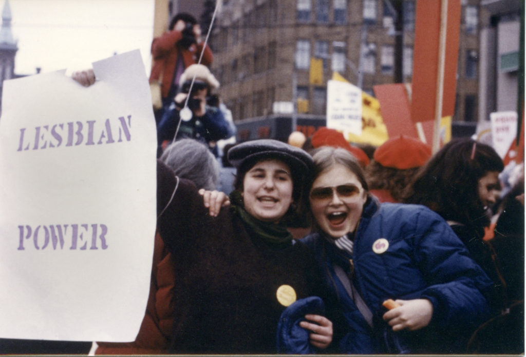 Lois Fine and Anne-Marie Smith hold Lesbian Power placard at Toronto International Women's Day March.