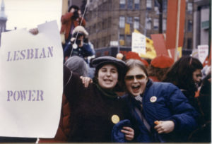 Lois Fine and Anne-Marie Smith hold Lesbian Power placard at Toronto International Women's Day March.