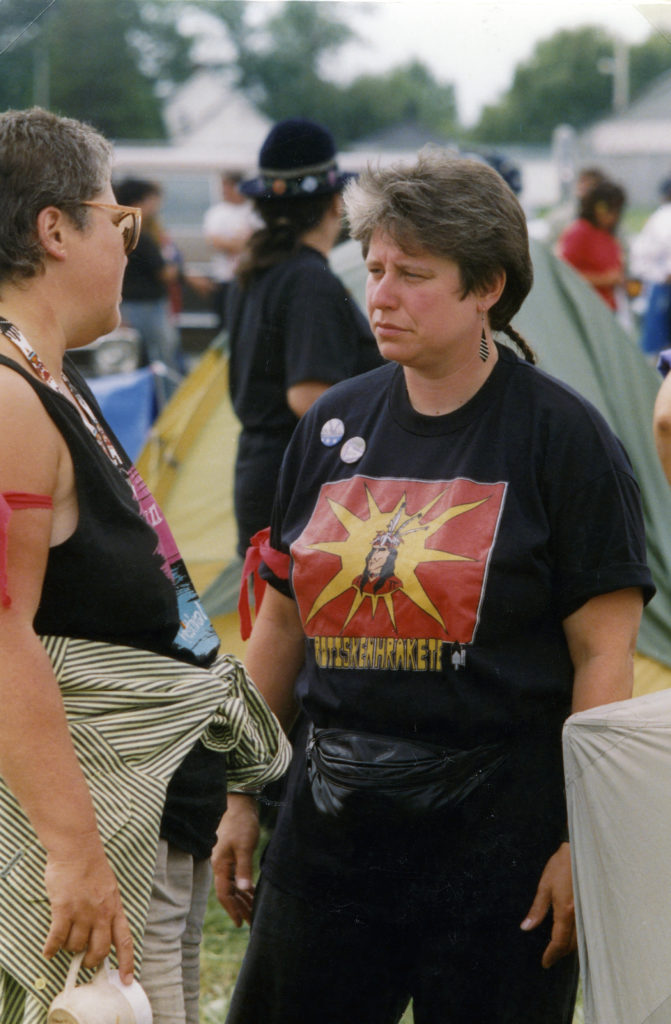 This photo is one of a number taken at the Oka Peace CamThis photo is one of a number taken at the Oka Peace Camp set up in July 1990 in solidarity with the Mohawks of Kanehsatake who rose up in defense of their ancestral lands after the Oka Golf Club proposed an extension and the building of luxury condos over a Mohawk ancestral graveyard in the sacred wooded area known as “The Pines”. This land had never been ceded. In early July, after the Mohawks refused to end their non-violent occupation of the area or to take down the barricade, the Sûreté du Québec (Quebec police) moved in resulting in a violent confrontation. Later, the Canadian army was called in. Mohawk women, including Ellen Gabriel, played a central role in the uprising, which lasted for 78 intense days (July 11 – September 26, 1990). In the end, the golf course was not extended, and the condos were not built. But the larger issues of land sovereignty have never been resolved.p set up in July 1990 in solidarity with the Mohawks of Kanehsatake who rose up in defense of their ancestral lands after the Oka golf course proposed an extension and the building of luxury condos over a Mohawk ancestral graveyard in the sacred wooded area known as “The Pines”. This land had never been ceded. In early July, after the Mohawks refused to end their non-violent occupation of the area and to take down the barricade, the Sûreté du Québec (Quebec police) moved in resulting in a violent confrontation. Later, the Canadian army was called in. Mohawk women, including Ellen Gabriel, played a central role in the uprising, which lasted for 78 intense days (July 11 – September 26, 1990). In the end the golf course was not extended and the condos were not built. But the larger issues of land sovereignty have never been resolved.