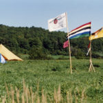 This photo is one of a number taken at the Oka Peace Camp set up in July 1990 in solidarity with the Mohawks of Kanehsatake who rose up in defense of their ancestral lands after the Oka Golf Club proposed an extension and the building of luxury condos over a Mohawk ancestral graveyard in the sacred wooded area known as “The Pines”. This land had never been ceded. In early July, after the Mohawks refused to end their non-violent occupation of the area or to take down the barricade, the Sûreté du Québec (Quebec police) moved in resulting in a violent confrontation. Later, the Canadian army was called in. Mohawk women, including Ellen Gabriel, played a central role in the uprising, which lasted for 78 intense days (July 11 – September 26, 1990). In the end, the golf course was not extended, and the condos were not built. But the larger issues of land sovereignty have never been resolved.