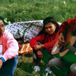 This photo is one of a number taken at the Oka Peace Camp set up in July 1990 in solidarity with the Mohawks of Kanehsatake who rose up in defense of their ancestral lands after the Oka Golf Club proposed an extension and the building of luxury condos over a Mohawk ancestral graveyard in the sacred wooded area known as “The Pines”. This land had never been ceded. In early July, after the Mohawks refused to end their non-violent occupation of the area or to take down the barricade, the Sûreté du Québec (Quebec police) moved in resulting in a violent confrontation. Later, the Canadian army was called in. Mohawk women, including Ellen Gabriel, played a central role in the uprising, which lasted for 78 intense days (July 11 – September 26, 1990). In the end, the golf course was not extended, and the condos were not built. But the larger issues of land sovereignty have never been resolved.