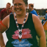 This photo is one of a number taken at the Oka Peace Camp set up in July 1990 in solidarity with the Mohawks of Kanehsatake who rose up in defense of their ancestral lands after the Oka Golf Club proposed an extension and the building of luxury condos over a Mohawk ancestral graveyard in the sacred wooded area known as “The Pines”. This land had never been ceded. In early July, after the Mohawks refused to end their non-violent occupation of the area or to take down the barricade, the Sûreté du Québec (Quebec police) moved in resulting in a violent confrontation. Later, the Canadian army was called in. Mohawk women, including Ellen Gabriel, played a central role in the uprising, which lasted for 78 intense days (July 11 – September 26, 1990). In the end, the golf course was not extended, and the condos were not built. But the larger issues of land sovereignty have never been resolved.