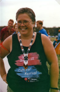 This photo is one of a number taken at the Oka Peace Camp set up in July 1990 in solidarity with the Mohawks of Kanehsatake who rose up in defense of their ancestral lands after the Oka Golf Club proposed an extension and the building of luxury condos over a Mohawk ancestral graveyard in the sacred wooded area known as “The Pines”. This land had never been ceded. In early July, after the Mohawks refused to end their non-violent occupation of the area or to take down the barricade, the Sûreté du Québec (Quebec police) moved in resulting in a violent confrontation. Later, the Canadian army was called in. Mohawk women, including Ellen Gabriel, played a central role in the uprising, which lasted for 78 intense days (July 11 – September 26, 1990). In the end, the golf course was not extended, and the condos were not built. But the larger issues of land sovereignty have never been resolved.