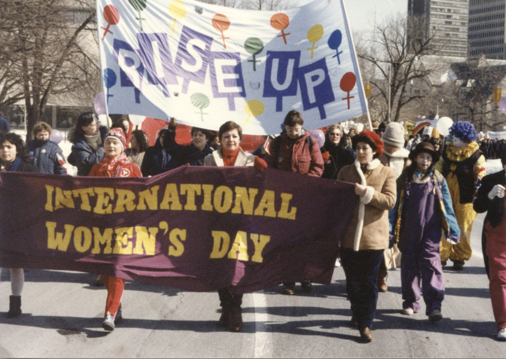 The theme of the 1984 International Women's Day in Toronto was Rise Up.