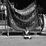 This is an undated photo of a protest held at Queen's Park showing banners of the Sole Support Parents Coalition.