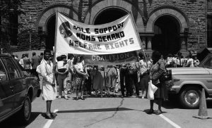 This is an undated photo of welfare rights protest at Queen's Park features banner of Sole Support Moms.