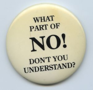 A button challenging rape myths and emphasizing that sexual activity without consent is coercive and abusive.