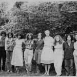 This is an undated group photo of the members of Women's Press. From left to right: Meg Luxton, Peggy McDonough, Brenda Roman, Naomi Wall, Lois Pike, Jane Springer, Daphne Read, Judy Skinner, Margie Wolfe, Connie Guberman, Wendy Donner, Judy (McClard) Blankenship