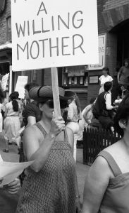 Supporter at 1983 rally in support of abortion rights outside the Morgentaler Clinic in Toronto. The Women's Bookstore can be seen in the background.