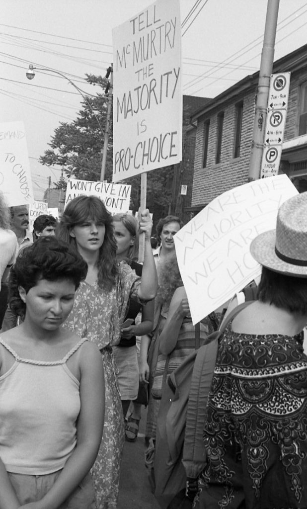 Pro-choice supporters rally outside Dr. Henry Morgentaler's clinic in Toronto. This 1983 protest was organized in support of Dr. Morgentaler and legalizing free-standing abortion clinics.