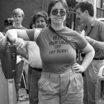 This is a photo of Diana Meredith taken at the 1983 abortion rights rally held outside the Morgentaler clinic in Toronto. Behind Diana are Joe Flexer and Frank Rooney.