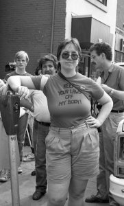 This is a photo of Diana Meredith taken at the 1983 abortion rights rally held outside the Morgentaler clinic in Toronto. Behind Diana are Joe Flexer and Frank Rooney.