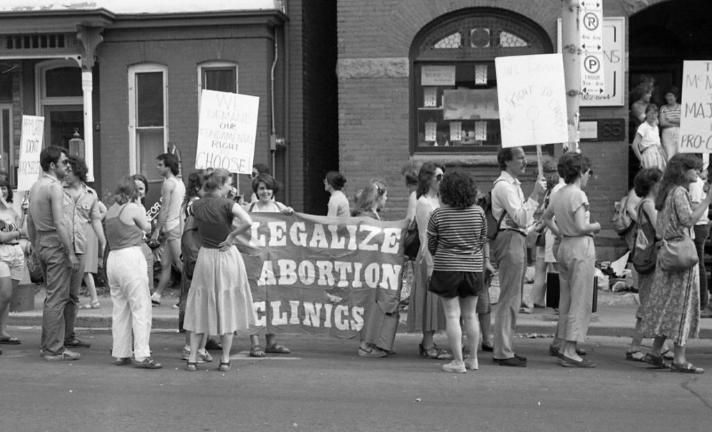 Protesters at rally outside Morgentaler Clinic in Toronto hold banner calling for the legalization of abortion clinics.