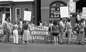 Protesters at rally outside Morgentaler Clinic in Toronto hold banner calling for the legalization of abortion clinics.