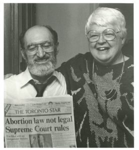 Norma Scarborough and Henry Morgentaler hold a copy of The Toronto Star with front-page headlines announcing the historic Supreme Court decision taken on January 28, 1988, stating that Canada's abortion law is not legal.