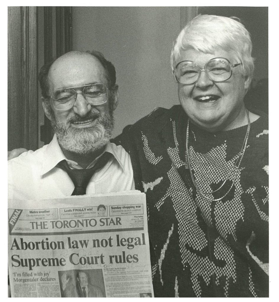 Norma Scarborough and Henry Morgentaler hold a copy of The Toronto Star with front-page headlines announcing the historic Supreme Court decision taken on January 28, 1988, stating that Canada's abortion law is not legal.