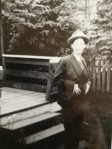 This is a photo of Anne Roberts dressed in a man's suit for the Vancouver May 8th March organized in solidarity with the Abortion Caravan and the Ottawa March. Anne and Jean Rands appeared as Health Ministers John Munro and Ralph Loffmark.