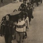 Protesters wearing headscarves climb stairs at the Parliament Building carrying a coffin during the outside protest on May 11th. Charlotte Bedard is the first pallbearer on the right.