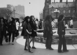 Protestors in headscarves circle the Centennial Flame on Parliament Hill during the outside protest on May 11th 1970. Inside protestors managed to disrupt the proceedings of the House of Commons and force an adjournment.