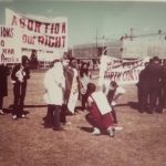 Members of the Abortion Caravan prepare for a Guerrilla Theatre skit during a stop on the Prairies.