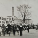 The sign "Abortion is Our Right" is prominent in this photo showing a long stretch of the May 9th Ottawa march organized to coincide with the arrival of the Abortion Caravan as it completed its cross-country trip to raise awareness of the issue.