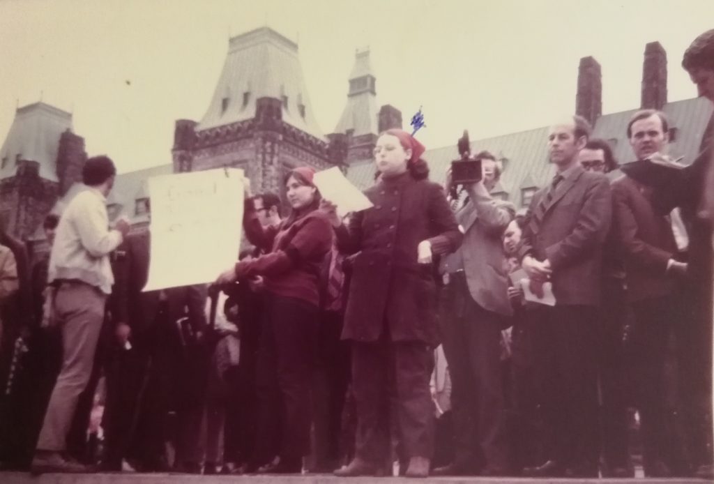 During the May 11th protest on Parliament Hill, Margo Dunn speaks to the media and supporters before Section 237 of the Criminal Code is symbolically burned. Sandra Conway is holding the "law".