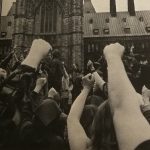 Women stand with fists raised in at a demonstration outside the Parliament Buildings on May 11, 1970, as protesters in the House of Commons galleries disrupt the sitting.