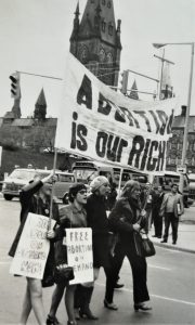 Vancouver women lead the Ottawa march down Wellington Street with a banner proclaiming "Abortion is Our Right". Gwen Hauser is on the right in the picture.