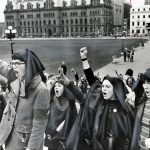 Women wearing headscarves and with raised fists gather on Parliament Hill during a May 11, 1970 protest for abortion rights. Inside the House of Commons, another group of women speaking from the galleries interrupted the session, forcing an adjournment until after they were removed.