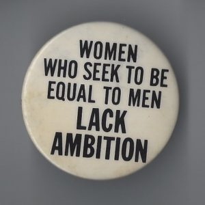 This button's slogan is "Women Who Seek To Be Equal To Men Lack Ambition"