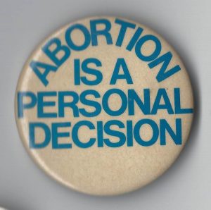 This is a button asserting a woman's personal right to decide about abortion