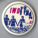 This is a button for International Women's Day in 1987.