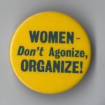 Button calling on women to organize for change.