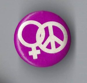 This button features intertwined symbols for Woman and Peace.