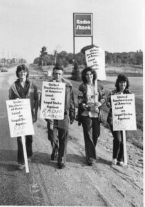 This photo was taken on the Radio Shack picket line in Barrie. The largely female workforce at Radio Shack's Barrie warehouse, organized by the United Steelworkers of Canada, went on strike for a first contract in August 1979. Issues included hazardous lifting conditions, no job security, inconsiderate treatment and favouritism. The Radio Shack strike was one of several lengthy strikes in Ontario led by women and marked by serious strike-breaking and anti-union tactics by the company. The strike ended in April 1980 after a court ruling that Radio Shack has bargained in bad faith. .