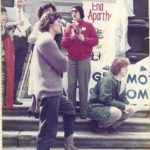 Onni Milne, Vancouver International Women's Day Committee member, with participants at the IWD Rally outside the Vancouver Art Gallery in 1985.