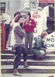 Onni Milne, Vancouver International Women's Day Committee member, with participants at the IWD Rally outside the Vancouver Art Gallery in 1985.