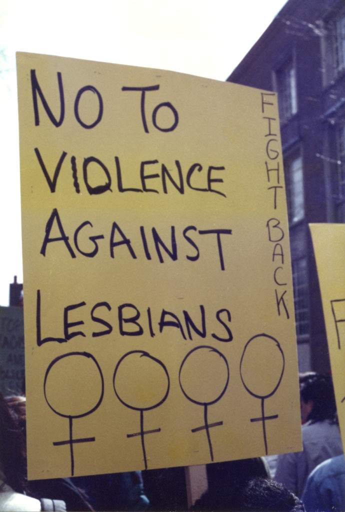 Placard at International Women's Day in Toronto calls for fighting back against violence against lesbians.