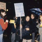 In response to the October 27, 1989, police shooting of 23-year-old Black woman Sophia Cook, the Black Women’s Collective organized the Women’s Coalition Against Racism and Police Violence. This coalition of 35 women’s and progressive organizations brought people together on December 16, 1989, to demand police accountability and an end to police brutality against Black people. This photo shows banners demanding that police put their guns away and calls for an Independent Civilian Review.