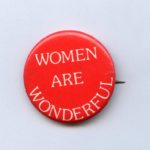 Whimsical button donated by Cathy Mulroy, an activist involved in winning access to jobs at INCO for women.