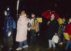 Carol Allain (in pink coat), member of the Black Women's Collective, is surrounded by others at protest against police violence. In response to the October 27, 1989, police shooting of 23-year-old Black woman Sophia Cook, the Black Women’s Collective organized the Women’s Coalition Against Racism and Police Violence. This coalition of 35 women’s and progressive organizations brought people together on December 16, 1989, to demand police accountability and an end to police brutality against Black people.