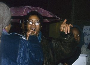 Dionne Brand, member of the Black Women's Collective, speaks at protest against police violence. In response to the October 27, 1989, police shooting of 23-year-old Black woman Sophia Cook, the Black Women’s Collective organized the Women’s Coalition Against Racism and Police Violence. This coalition of 35 women’s and progressive organizations brought people together on December 16, 1989, to demand police accountability and an end to police brutality against Black people.