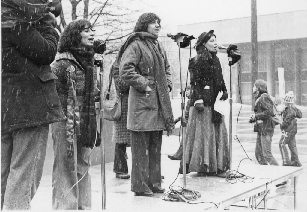 Varda Burstyn, Deirdre Gallahger and Debbie Field perform at the International Women's Day Rally in Toronto.